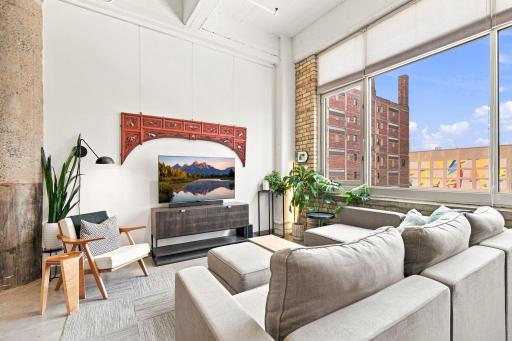 Living room with downtown views. There is a picture rail for hanging decor which runs along the entire wall.