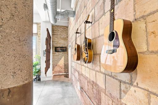 Hallway to primary bedroom. Note the beautiful terra-cotta brick wall.