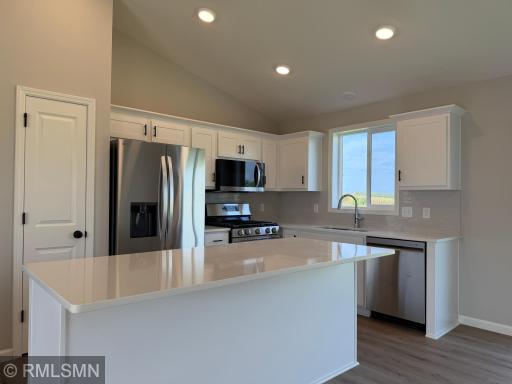 Kitchen with island and white quartz countertops