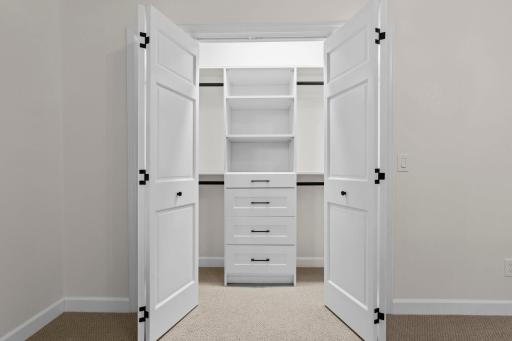 All bedroom closets offer Custom built-in closet with floor-to-ceiling shelving, drawers, and hanging space. Thoughtful storage solutions throughout every room.