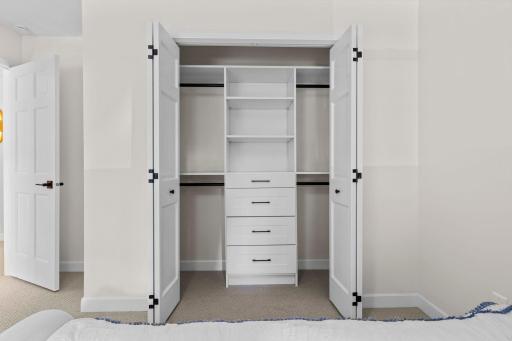 Additional lower level storage or flex closet with built-in shelving and drawers, keeping the home organized from top to bottom.