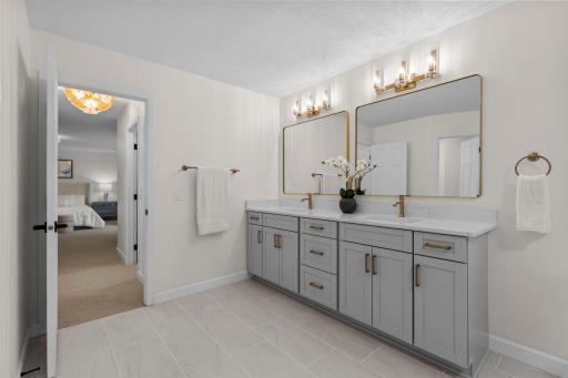 Second angle of the primary bath showcasing the full dual vanity layout, generous counter space, and a clean, spa-like finish throughout.