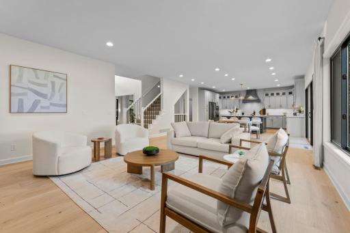 Inviting living area with warm neutral tones, designer furnishings, and an effortless connection to the rest of the main level.