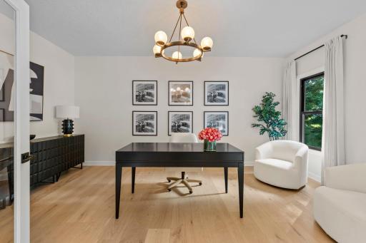 Elegant sitting room or flex space featuring curated artwork, a statement chandelier, and a versatile layout to suit your lifestyle.