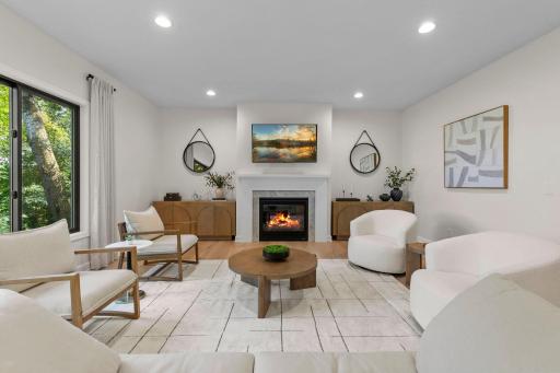 Living room with a gas fireplace, warm hardwood floors, and a bright, airy feel perfect for relaxing or entertaining.