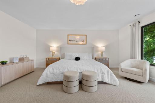 Primary bedroom featuring a soft neutral palette, generous proportions, and a layout designed for rest and relaxation.