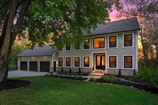 Gorgeous twilight exterior with warm glowing windows, classic architecture, and manicured landscaping. This home is as beautiful at dusk as it is by day.