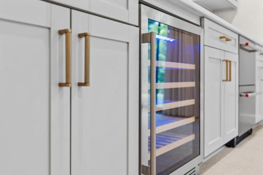 Built-in wine cooler with gold hardware and a backlit display. A refined touch for the wine enthusiast in the family.