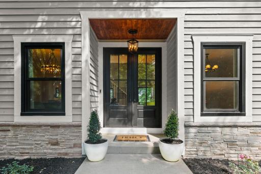 A grand entrance sets the tone, elegant double doors, designer lighting, and impeccable architectural detail welcome you home.