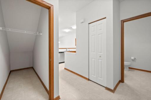 Coat closet under the stairs helps keep everyday essentials organized and tucked away
