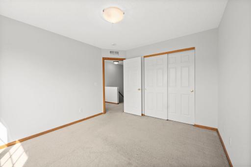 Another view highlights the bedroom’s generous closet space and comfortable space