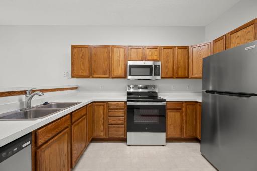 Kitchen with abundant cabinetry and new microwave, stove/oven, and dishwasher, plus a refrigerator that's just one year old