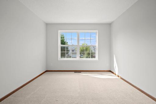 Bright and comfortable second bedroom with a large window and plenty of space to make it your own