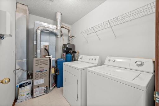 The upper level laundry/utility room keeps laundry tucked away and offers additional shelving and storage space