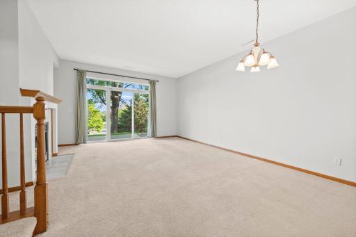 Bright, open dining space offers plenty of room for a full-size table and flows easily into the adjoining living room
