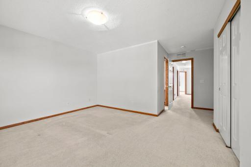 The spacious primary suite offers flexibility for a sitting area, desk, or additional furniture while still feeling open and comfortable and includes and ensuite bath