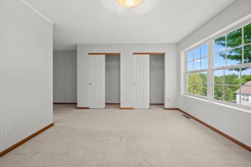 Another view of the generous primary bedroom highlights the great closet space and plenty of room for a full bedroom set