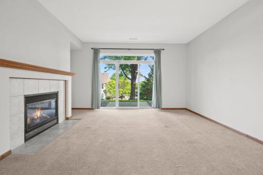 Spacious living room with sliding glass doors that bring in natural light and lead directly to the backyard patio