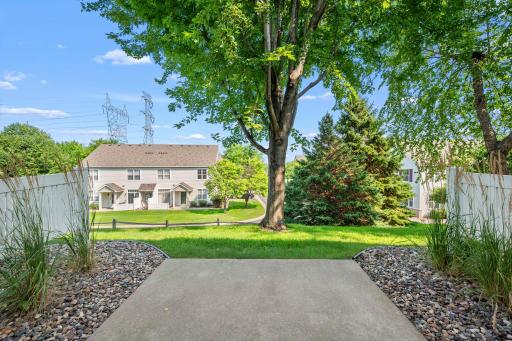 Step outside to the patio and enjoy a peaceful backyard setting with a privacy fence and mature trees