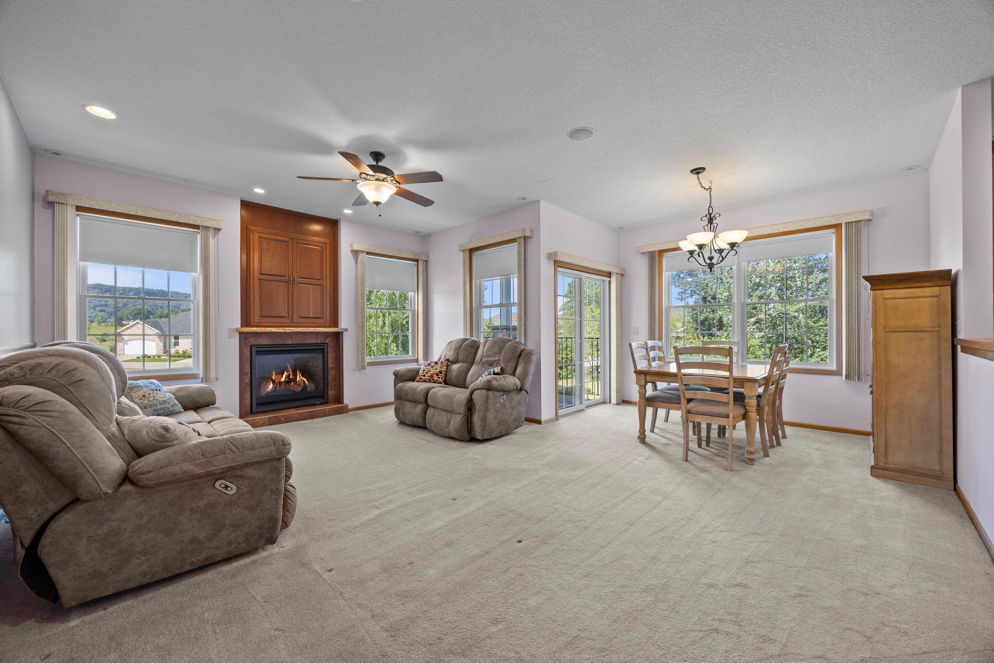 Bright, open living and dining space with gas fireplace