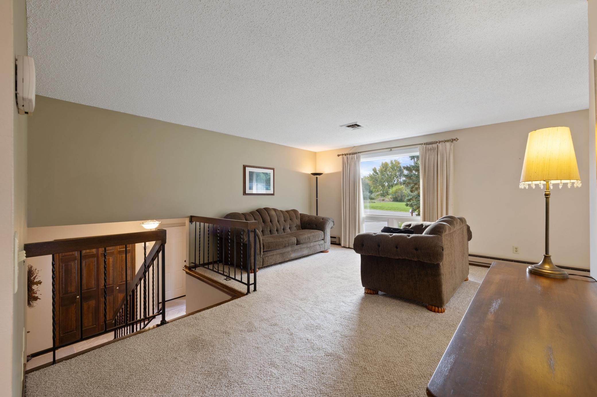 View from the hallway into the large upper living room with oversized windows