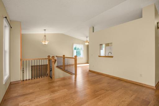 A peek back at the entry with the informal dining and kitchen just to the right. Vaults, lots of windows and beautiful floors.