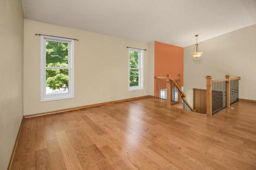 Expansive living area with engineered hardwood, sun drenched windows and high ceilings!