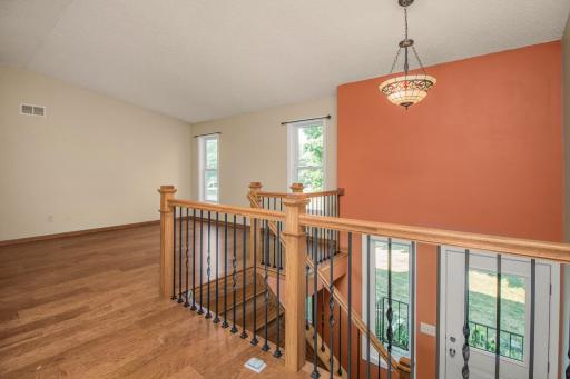 Entry is clean and bright with wood stairs and updated railings.