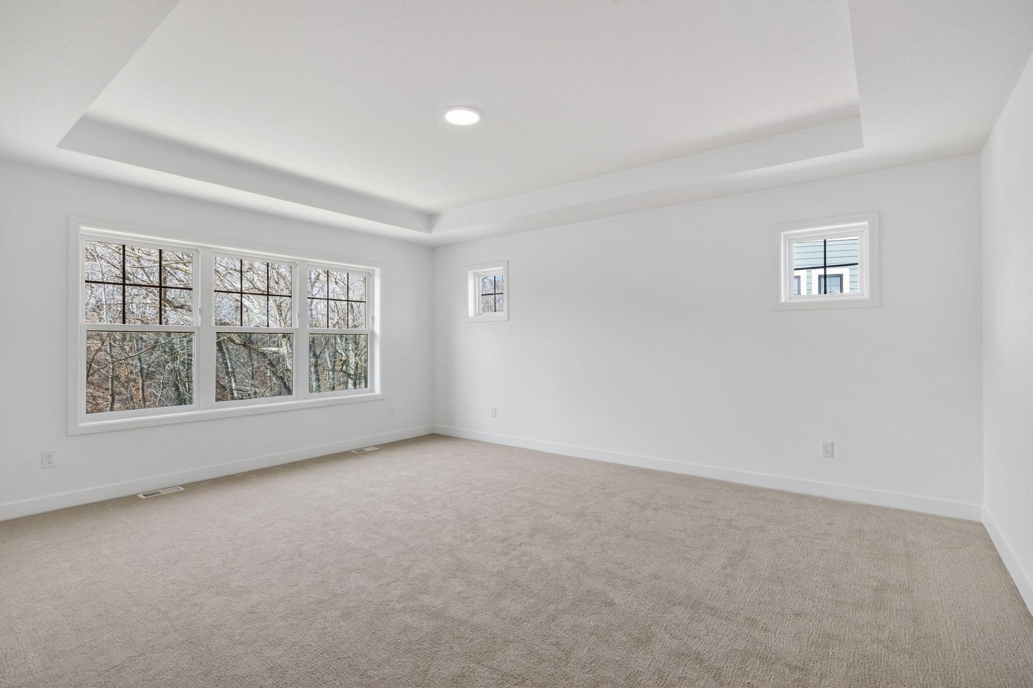 (Photo of a similar home, actual finishes may vary) Offering a private retreat made for rest and relaxation, the second-floor owner’s suite provides space for a seating area, a walk-in closet and a spa-inspired bathroom.