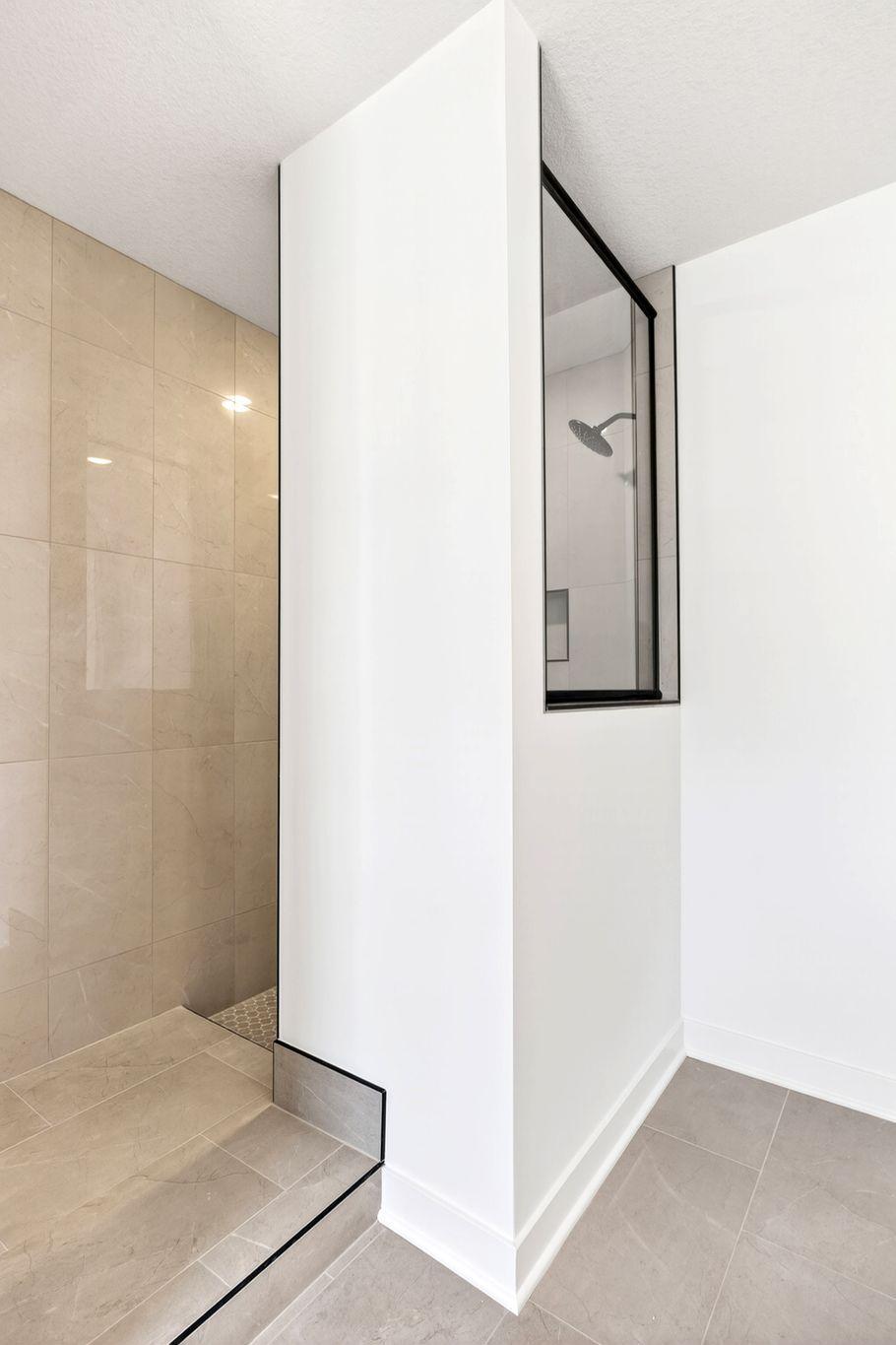 (Photo of a similar home, actual finishes may vary) A luxe soaking tub and a Serenity shower contribute to a spa-like atmosphere