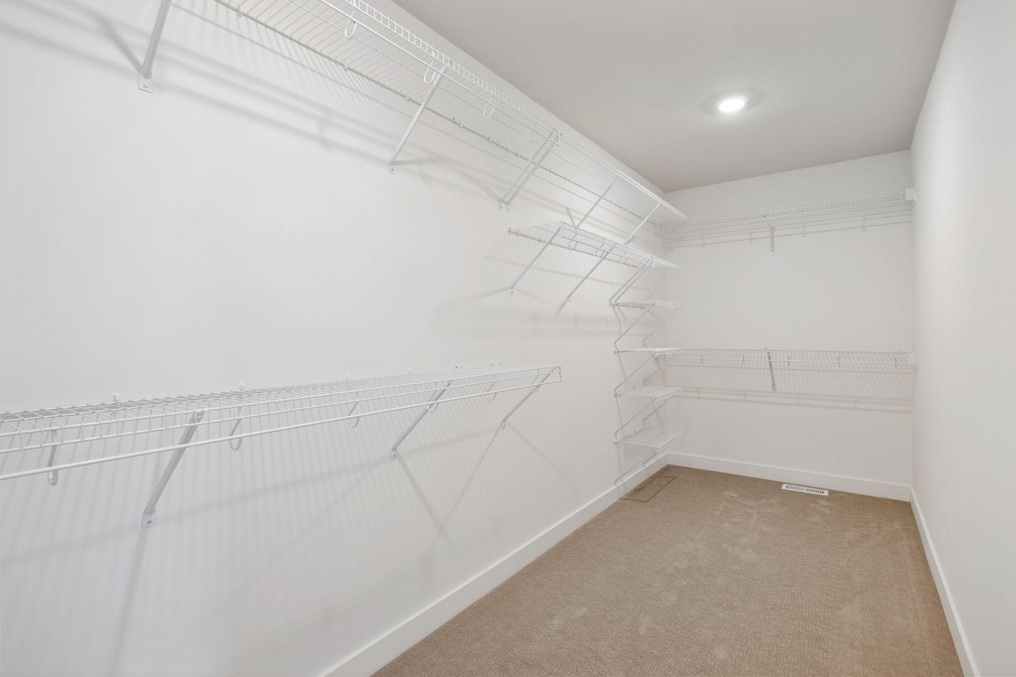 (Photo of a similar home, actual finishes may vary) Expansive walk-in closet in owner's suite
