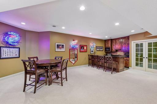 Spacious lower level with custom wet bar makes entertaining effortless.