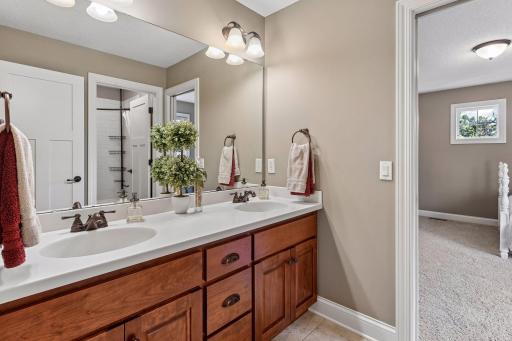 The Jack and Jill bathroom features a spacious dual-sink vanity with ample storage.