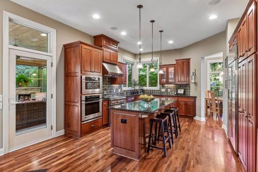 Spacious kitchen features GE Monogram appliances and generous island seating.