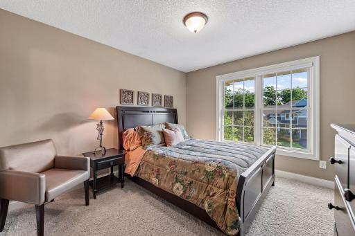 Another inviting upper-level bedroom filled with natural light.