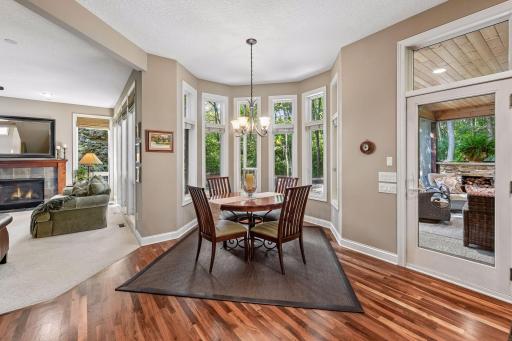 Casual dining area enjoys abundant natural light and peaceful wooded views.
