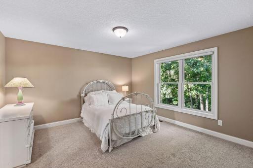 Generously sized secondary bedroom with large window and abundant natural light.