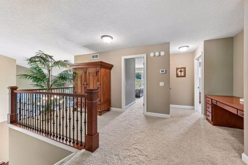 Spacious upper landing connects the bedrooms while maintaining an open, airy feel.