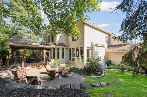 Professionally landscaped backyard offers beautiful spaces for relaxing and entertaining.