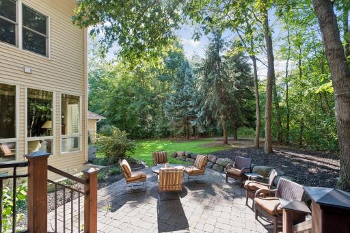Expansive paver patio creates an inviting outdoor gathering space.