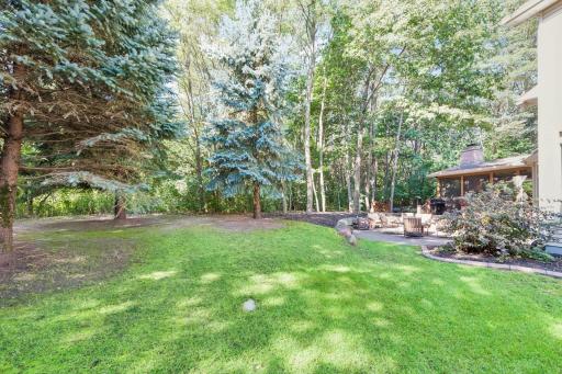 Exceptionally private backyard surrounded by mature trees and lush landscaping.