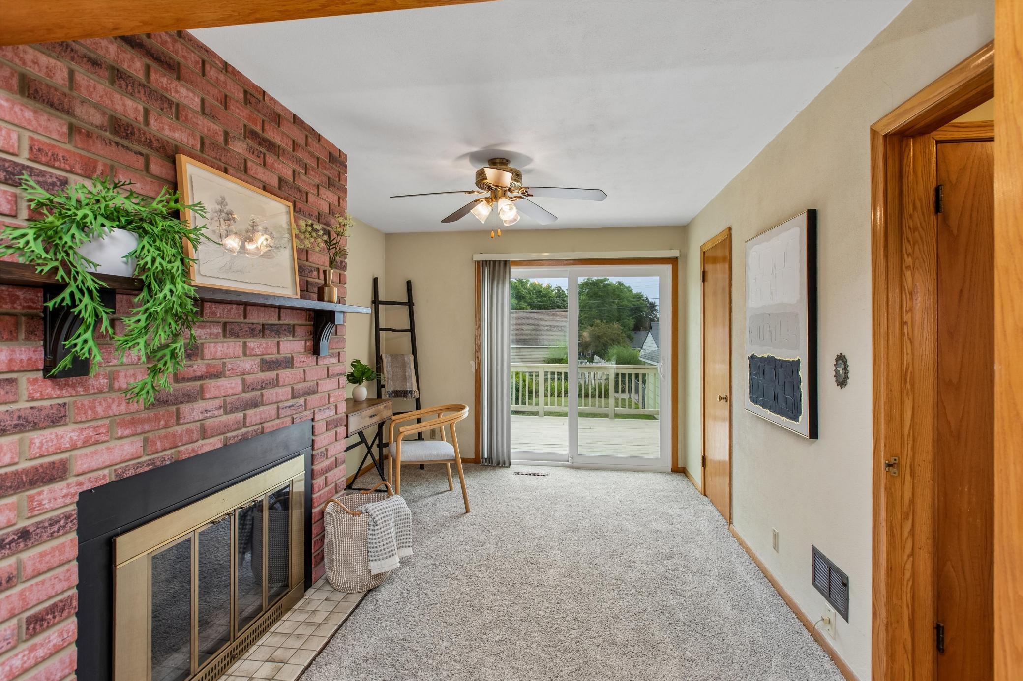 Cozy office/hearth room leading to deck. Hardwood floors under all main floor carpet!
