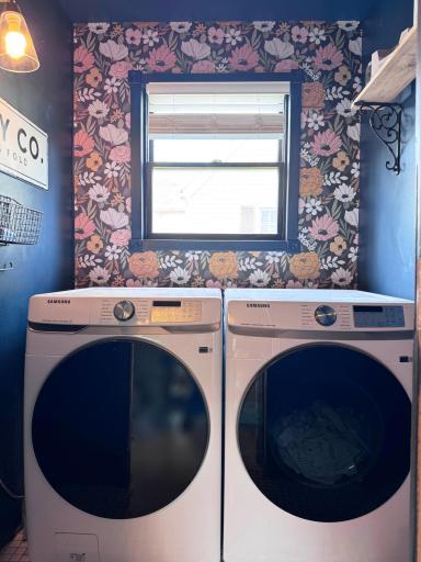 Views of the laundry room just off to the side of the kitchen. "Smart" washer/dryer...