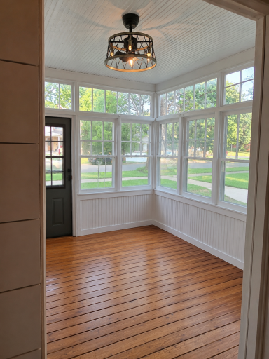 Views of the 3-season entry porch with lovely hardwood floors.