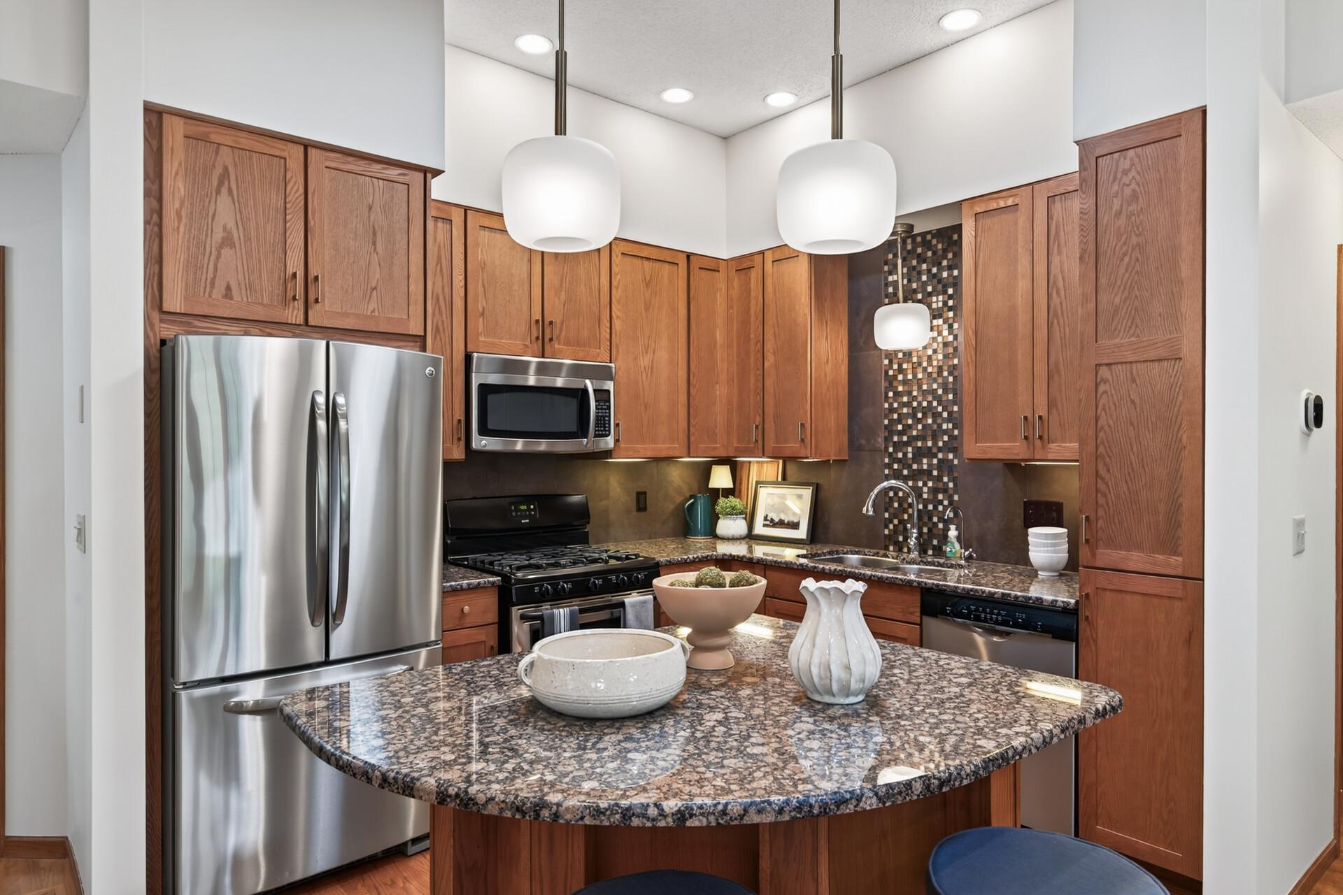 Granite countertops, stainless steel appliances, abundant cabinetry, and updated lighting.