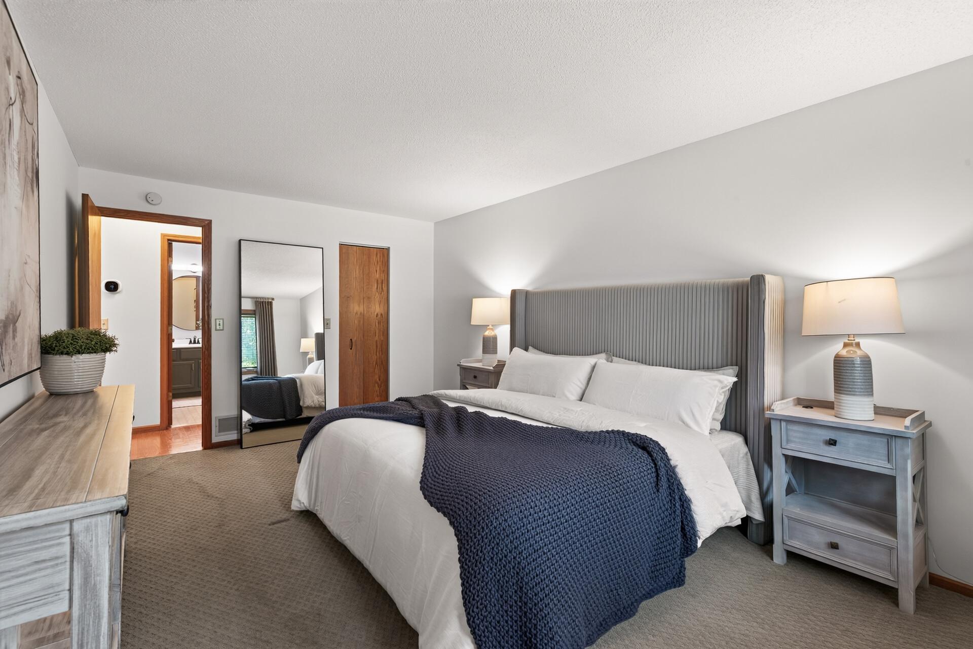 A spacious primary bedroom offers room to unwind after enjoying everything Northeast has to offer.
