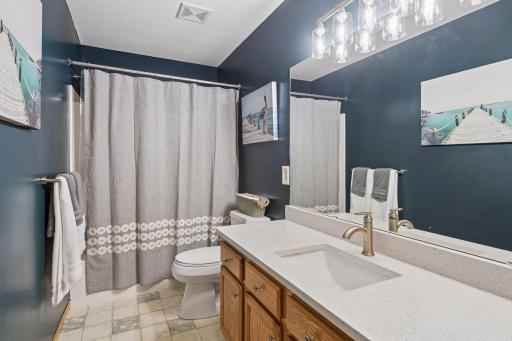Main floor full bathroom also with new quartz countertops, sink, and fixtures.