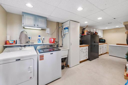 Finished laundry room with laundry sink. Incredible storage capacity inside and out. High quality, upper end Maytag washer and dryer.