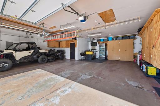 Insulated 4-car garage with heat and air conditioning. Tons of cabinet storage plus pull down steps to the attic. Garage utility sink with hot and cold water. A dream garage set up!