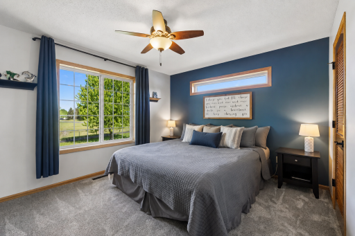 Spacious primary bedroom with private bathroom and large walk-in closet! There is an insert to darken the transom type window